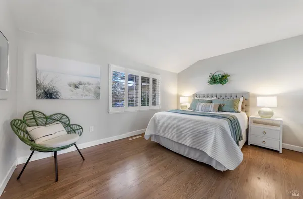 a bedroom with a bed and a chair