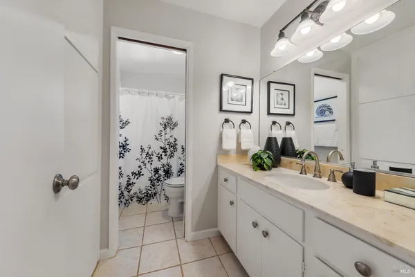 a bathroom with a shower sink and mirror