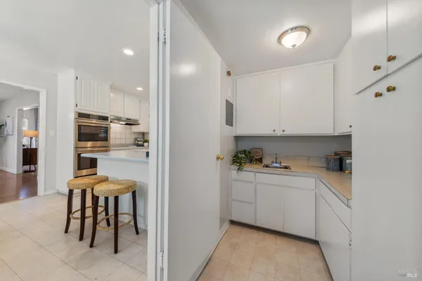 a kitchen with stainless steel appliances kitchen island granite countertop a sink and cabinets