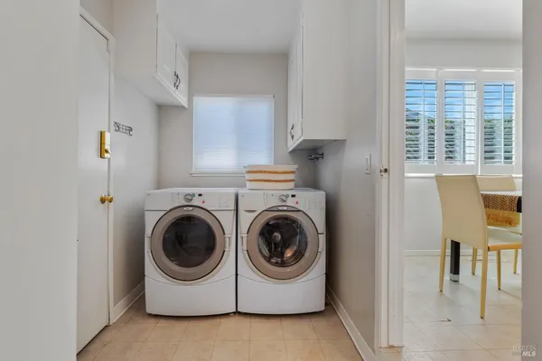 a utility room with sink dryer and washer