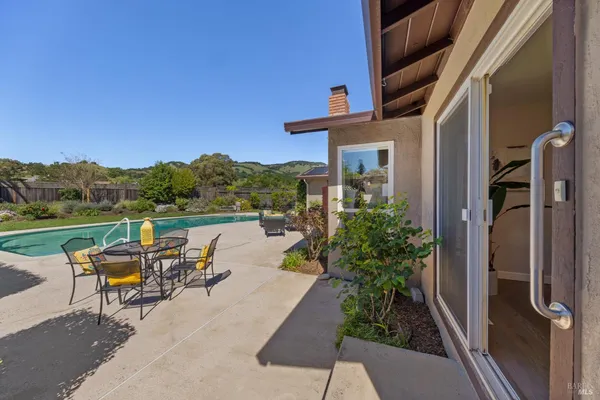 a view of a house with backyard sitting area and garden