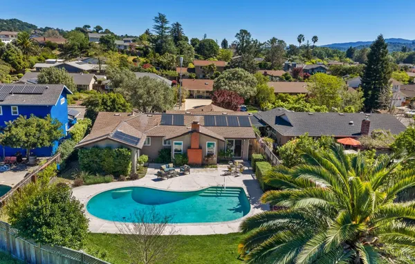 an aerial view of a house with garden space and lake view