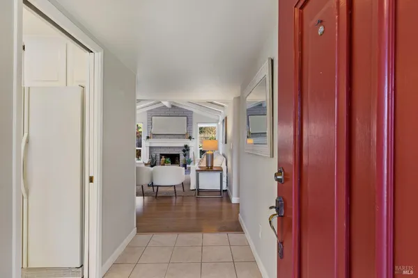 a view of a hallway and dining room with furniture