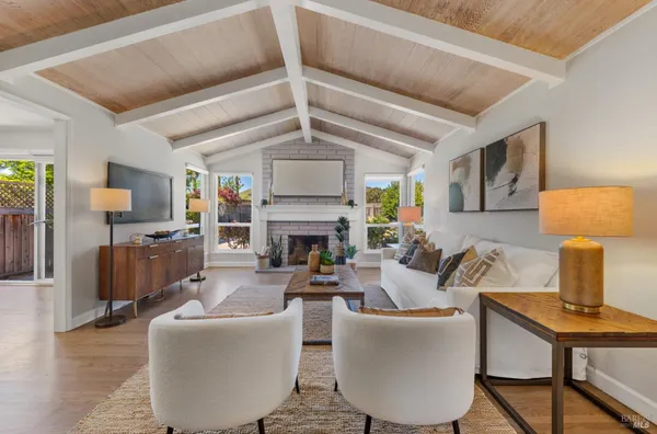 a living room with fireplace furniture and a wooden floor