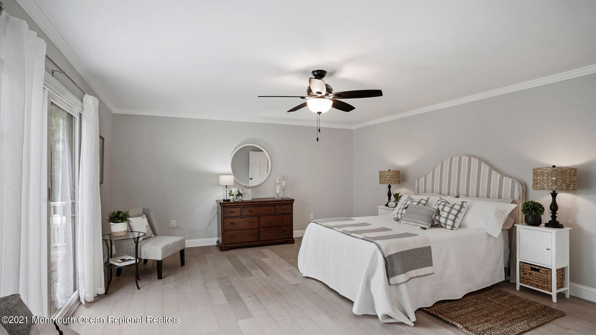 28 Driftway Road Howell, NJ 07731 - Photo 16 of 47 a bedroom with a bed and a chandelier