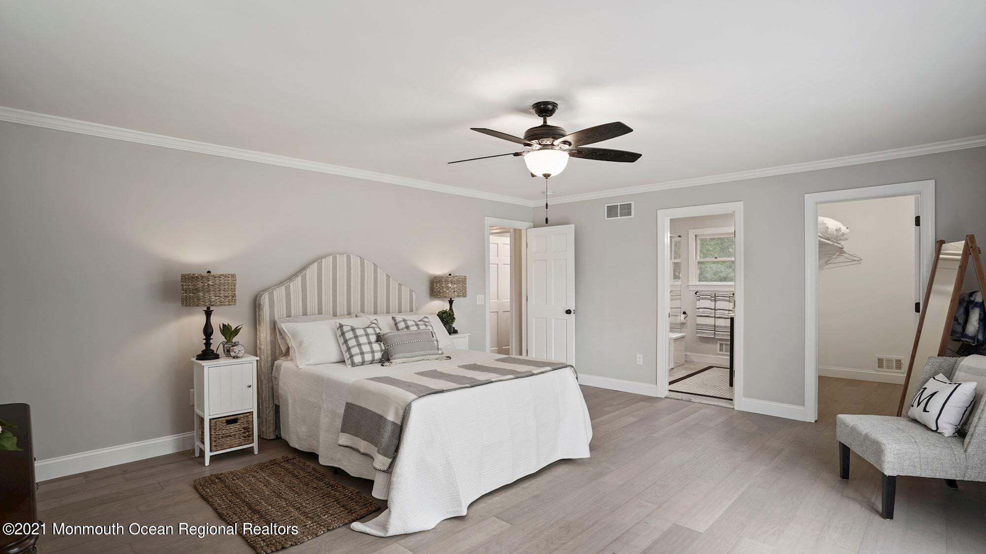 28 Driftway Road Howell, NJ 07731 - Photo 18 of 47 a spacious bedroom with a bed and a chandelier