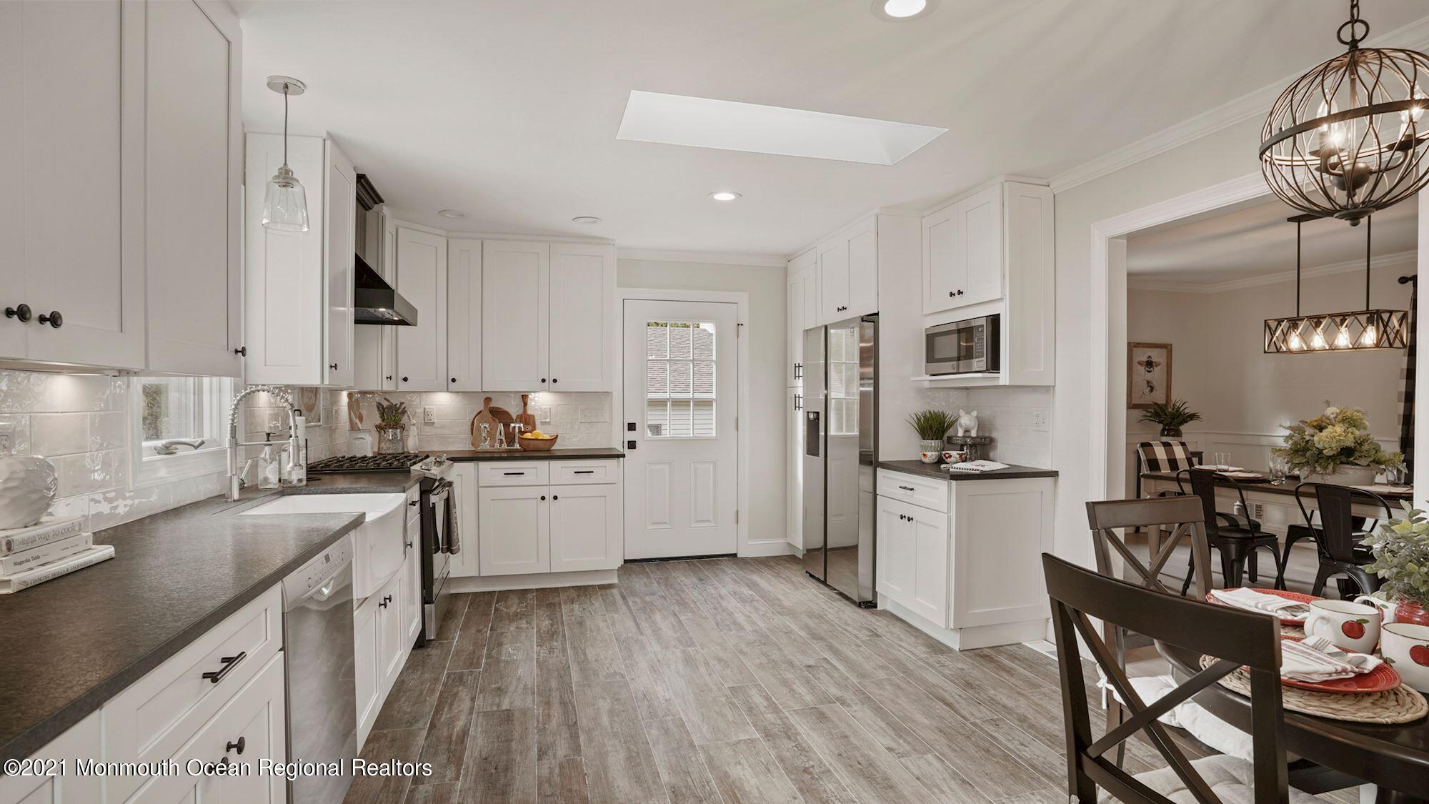 28 Driftway Road Howell, NJ 07731 - Photo 3 of 47 a kitchen with granite countertop white cabinets and white appliances