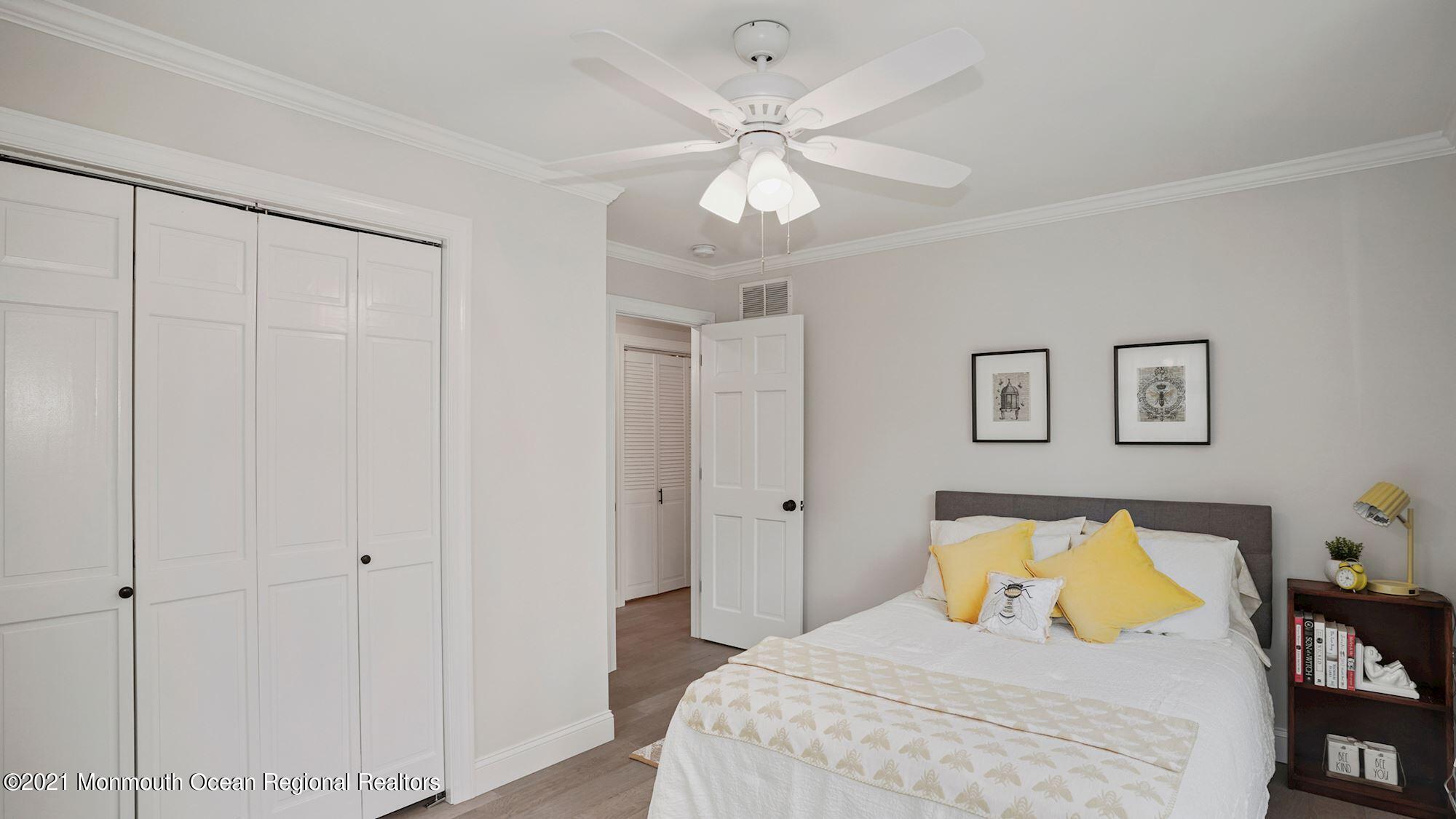 28 Driftway Road Howell, NJ 07731 - Photo 27 of 47 a bedroom with a bed and a chandelier