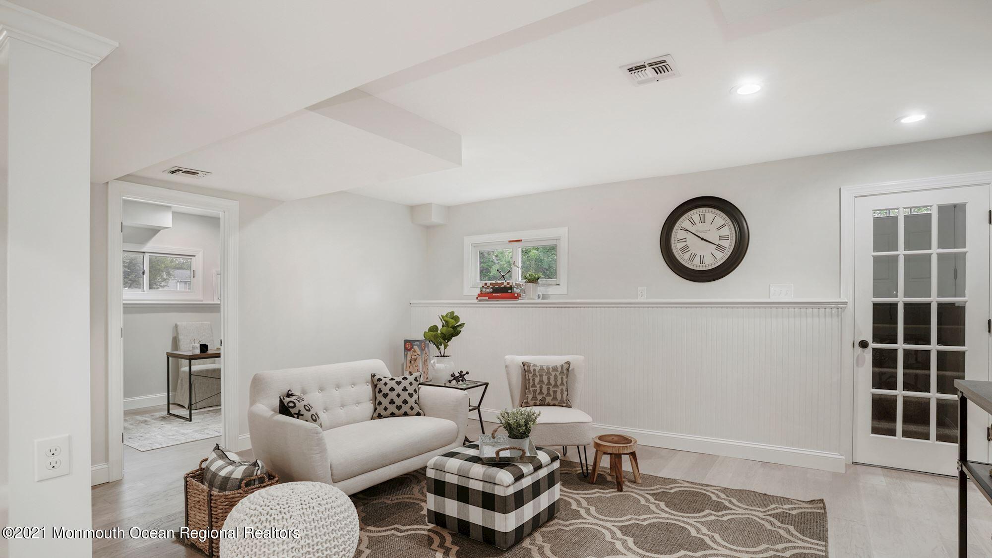 28 Driftway Road Howell, NJ 07731 - Photo 30 of 47 a living room with furniture a clock and a lamp