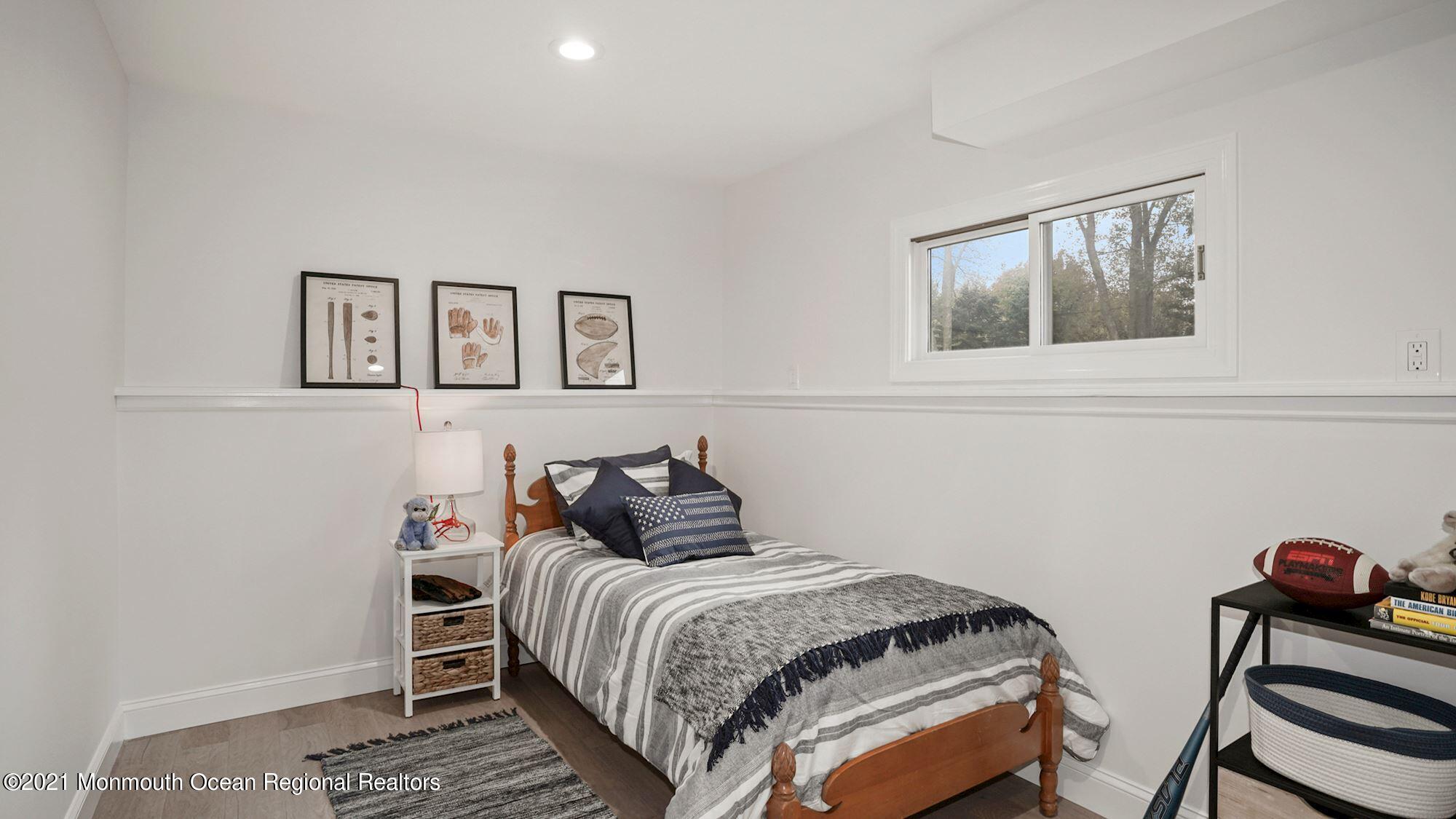 28 Driftway Road Howell, NJ 07731 - Photo 32 of 47 a bedroom with a bed and painting on the wall