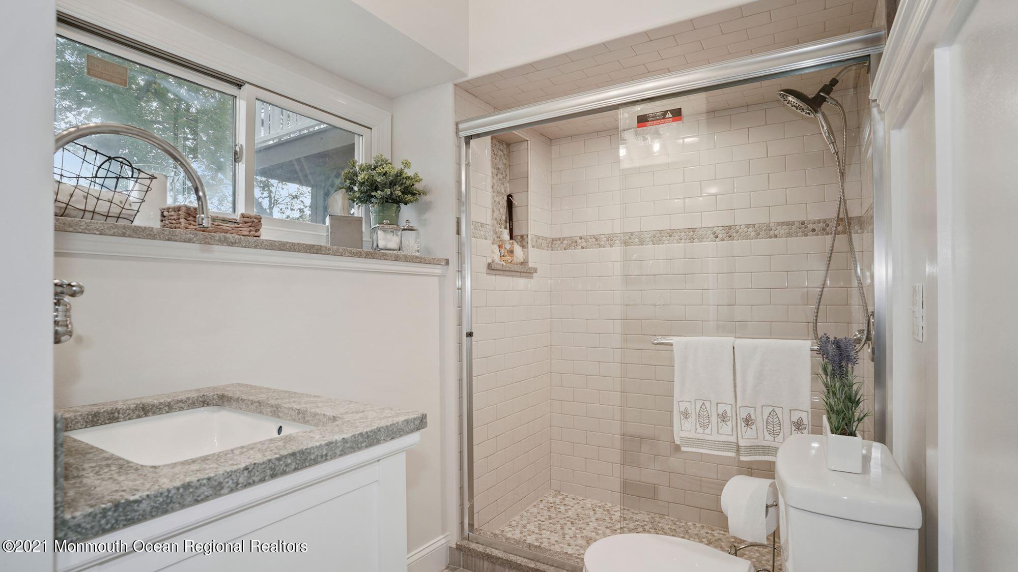 28 Driftway Road Howell, NJ 07731 - Photo 34 of 47 a bathroom with a granite countertop sink toilet and shower