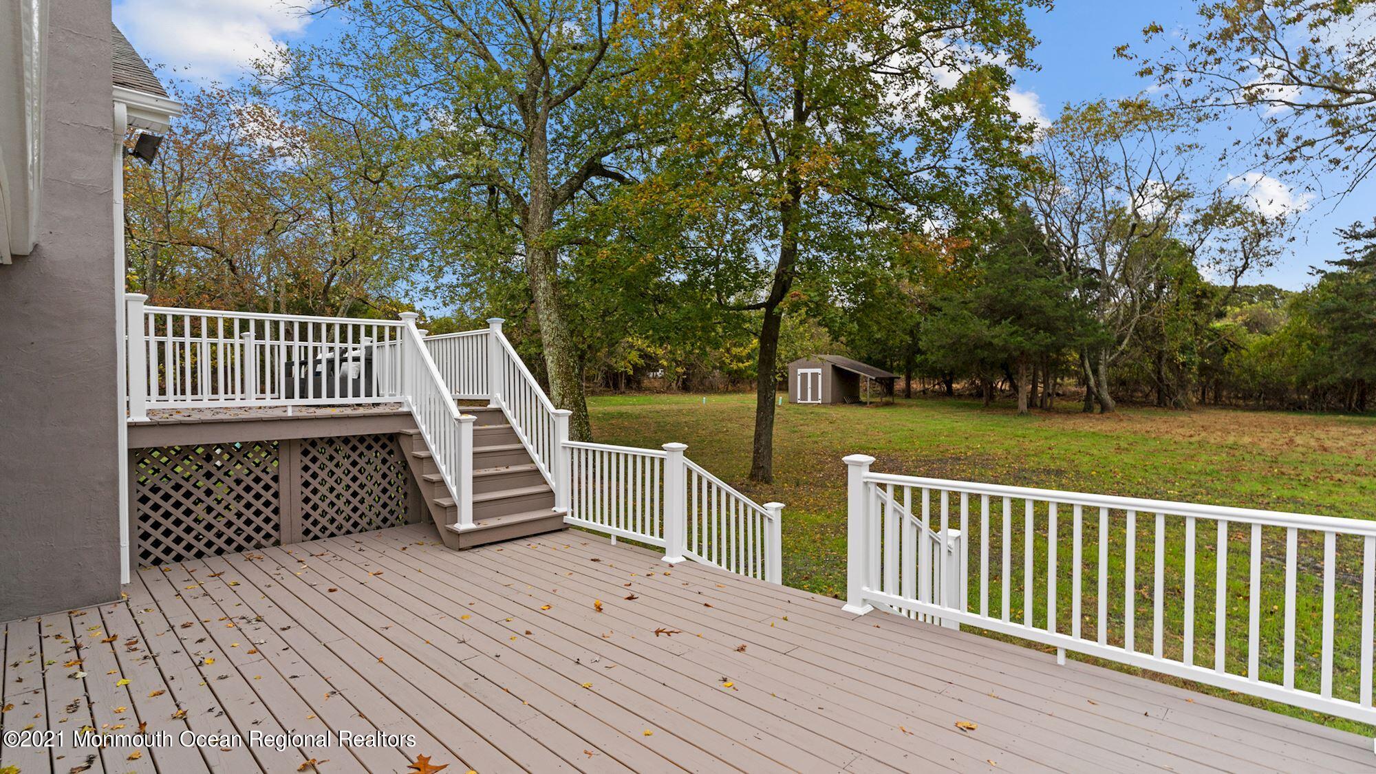 28 Driftway Road Howell, NJ 07731 - Photo 37 of 47 a view of a wooden deck with a yard