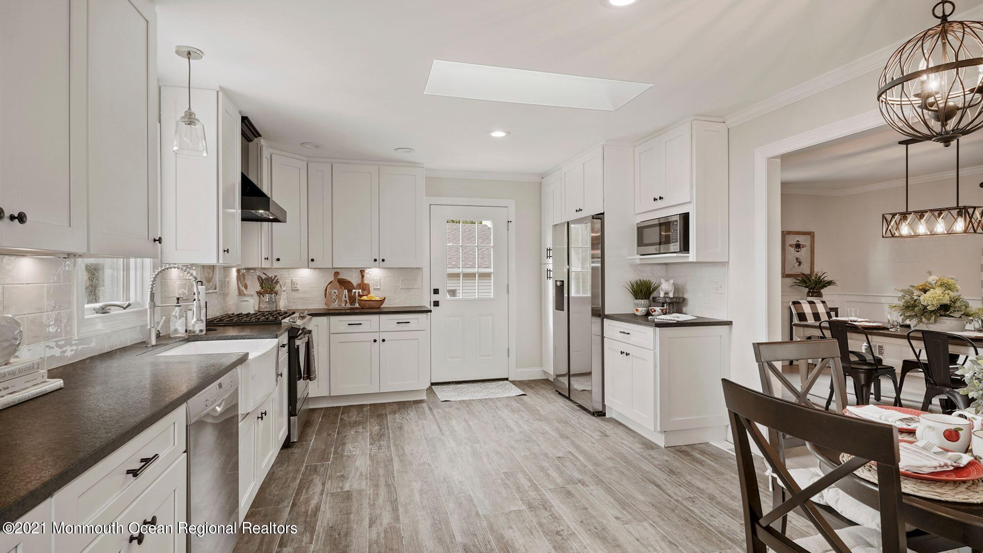 28 Driftway Road Howell, NJ 07731 - Photo 5 of 47 a kitchen with granite countertop white cabinets and white appliances