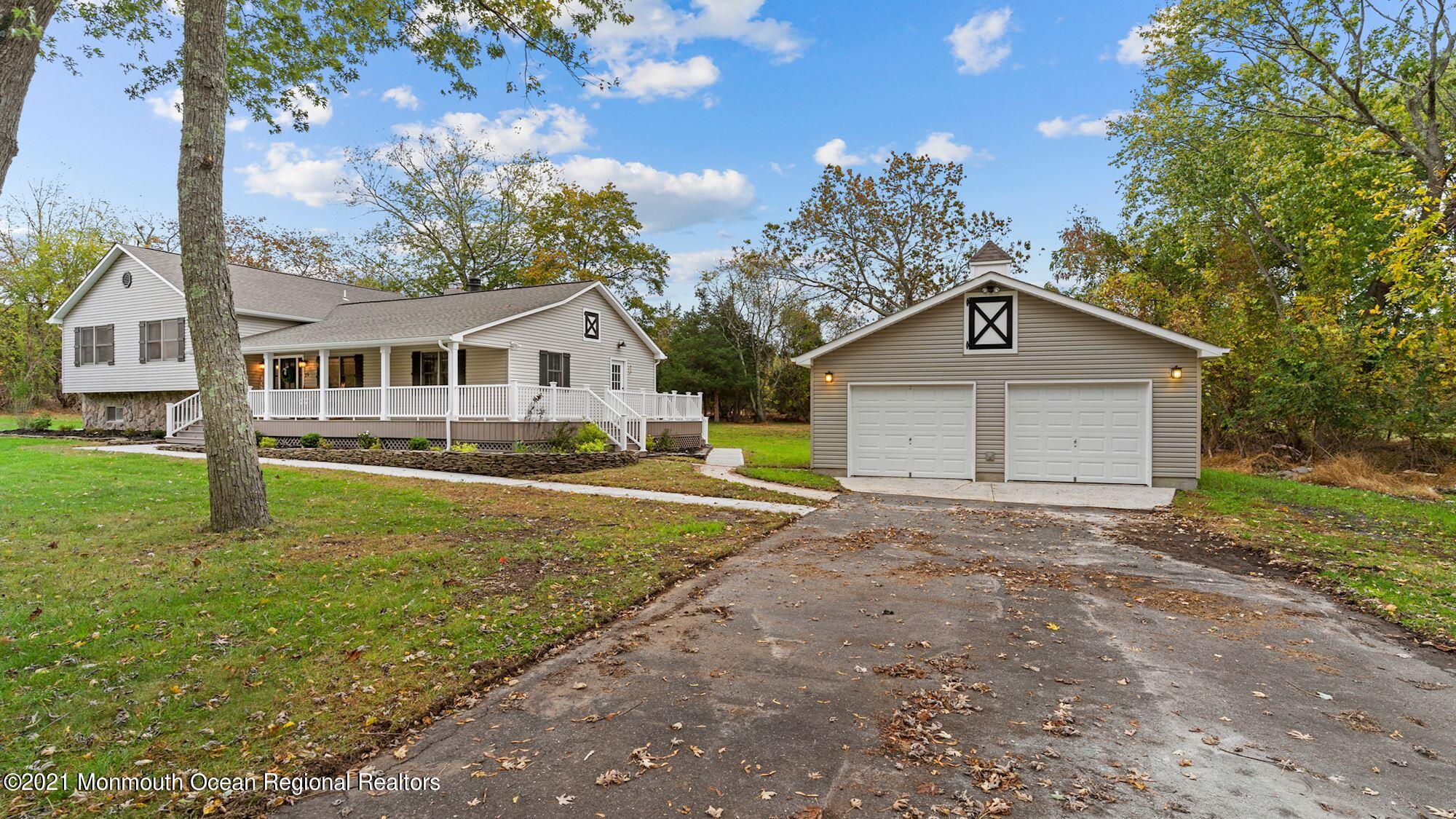 28 Driftway Road Howell, NJ 07731 - Photo 44 of 47 a front view of a house with a yard and garage