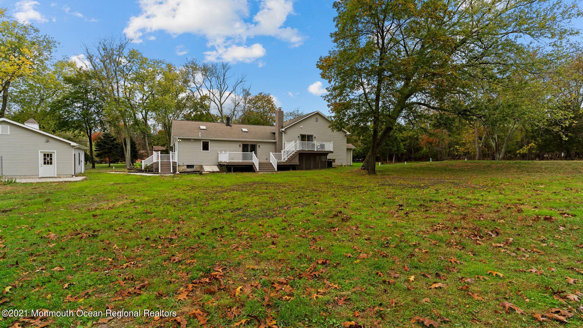 28 Driftway Road Howell, NJ 07731 - Photo 46 of 47 a view of a house with a big yard and large trees