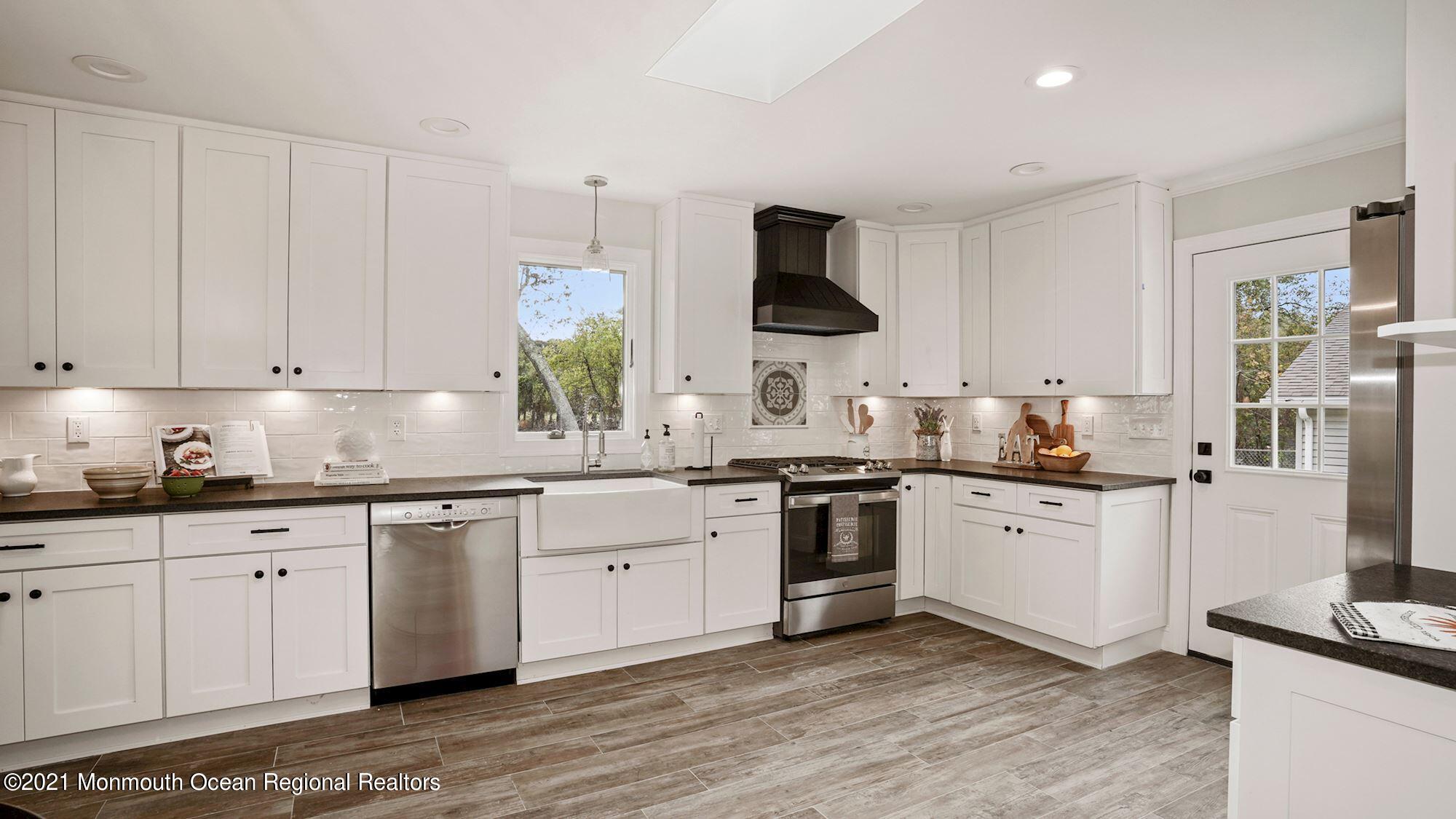 28 Driftway Road Howell, NJ 07731 - Photo 8 of 47 a kitchen with stainless steel appliances granite countertop a sink stove and refrigerator