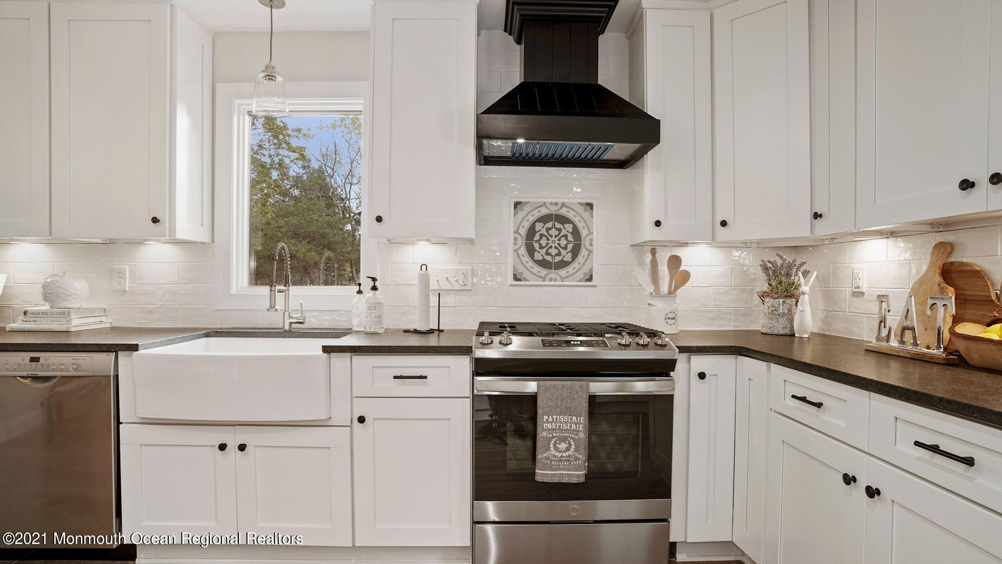 28 Driftway Road Howell, NJ 07731 - Photo 9 of 47 a kitchen with granite countertop white cabinets and white appliances