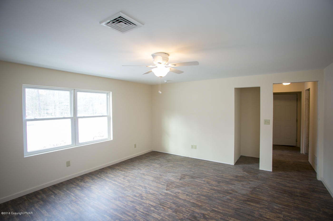 20 Cedar Road Mount Pocono, PA 18344 - Photo 33 of 43 an empty room with wooden floor chandelier fan and windows