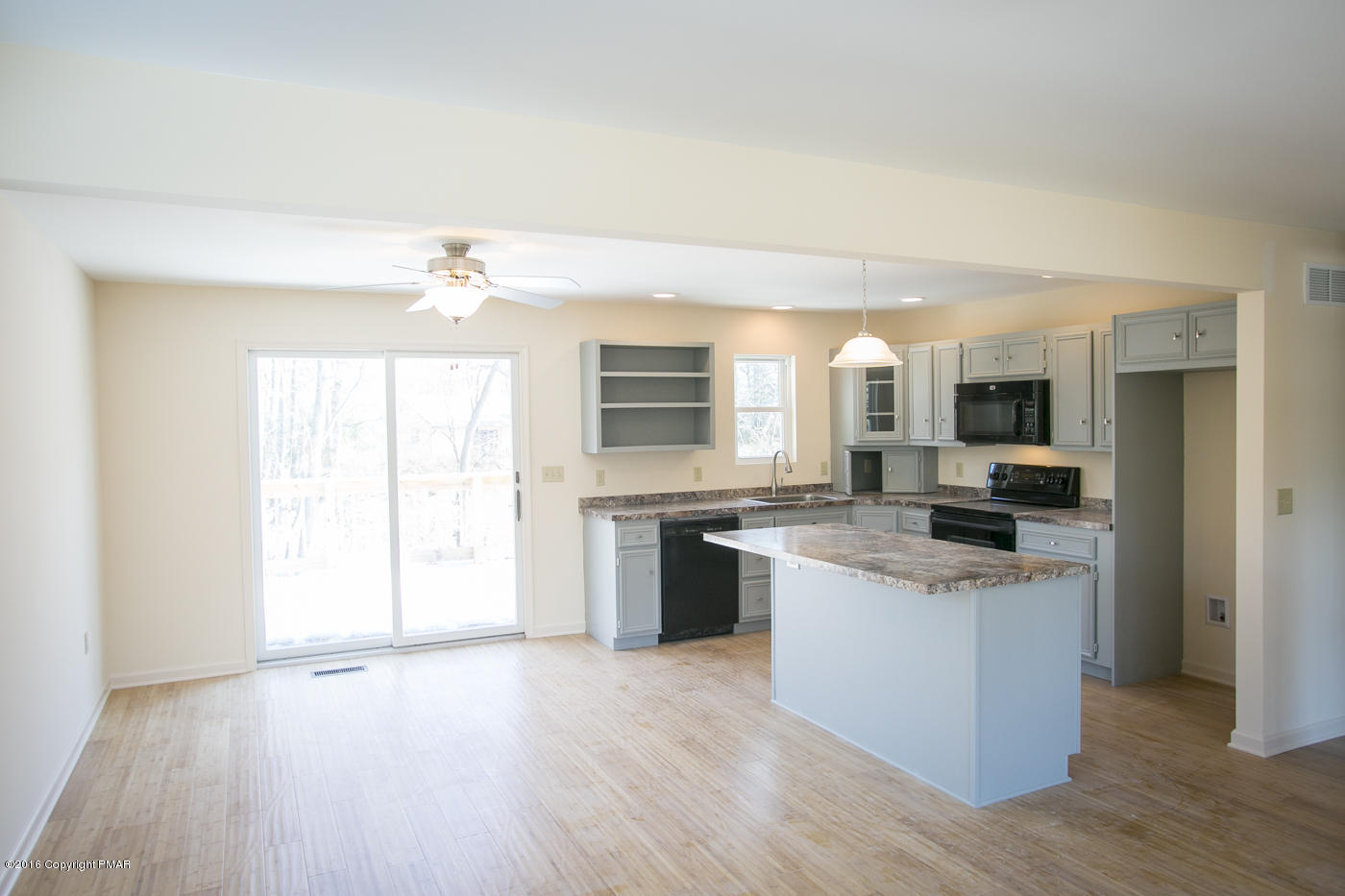 20 Cedar Road Mount Pocono, PA 18344 - Photo 9 of 43 a kitchen with stainless steel appliances granite countertop a stove top oven a sink dishwasher and a refrigerator with wooden floor