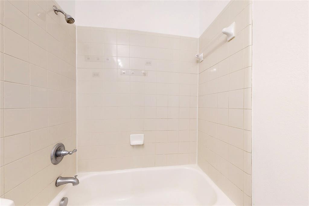 14908 Riverside Drive Little Elm, TX 75068 - Photo 19 of 40 Bathtub with subway tile surround, chrome showerhead, and matching chrome fixtures