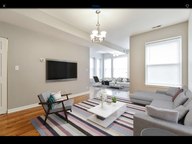6704 South Ridgeland Avenue, Unit 2D Chicago, IL 60649 - Photo 4 of 11 a living room with furniture a flat screen tv and a window