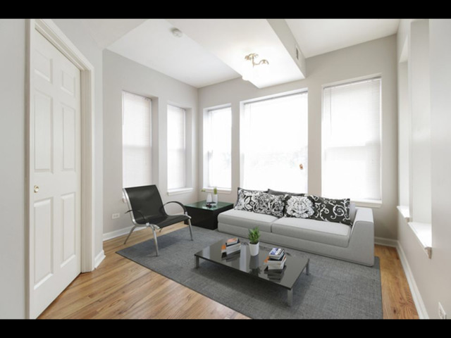 6704 South Ridgeland Avenue, Unit 2D Chicago, IL 60649 - Photo 5 of 11 a living room with furniture and a large window