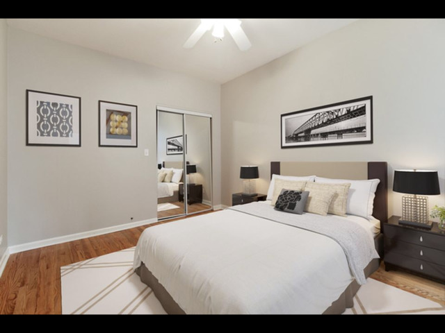 6704 South Ridgeland Avenue, Unit 2D Chicago, IL 60649 - Photo 6 of 11 a bedroom with a bed and wall painting