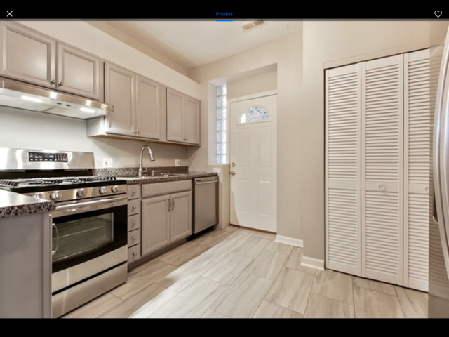 6704 South Ridgeland Avenue, Unit 2D Chicago, IL 60649 - Photo 8 of 11 a kitchen with stainless steel appliances granite countertop a stove a sink and a refrigerator