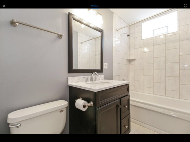 6704 South Ridgeland Avenue, Unit 2D Chicago, IL 60649 - Photo 9 of 11 a bathroom with a sink a toilet and shower