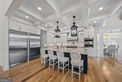 a view of a dining room with furniture a rug and wooden floor