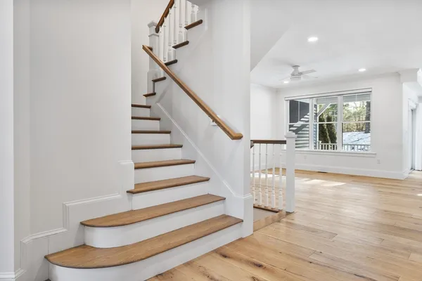 a view of entryway and hall with wooden floor