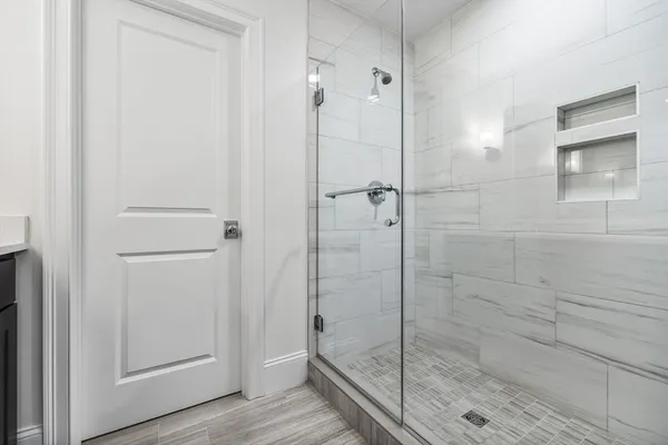 a bathroom with a glass shower door