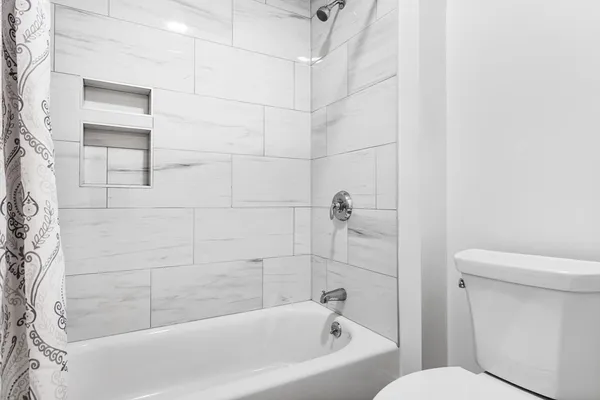 a bathroom with a bathtub and a toilet