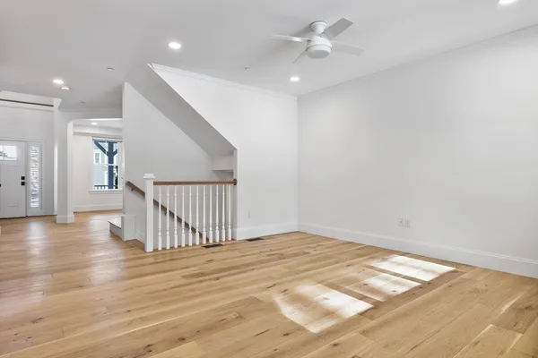 a view of an empty room with wooden floor