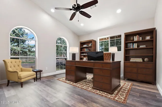 a work room with furniture and a large window