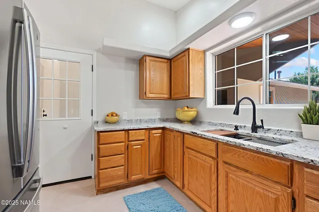 a kitchen with stainless steel appliances granite countertop a sink stove and cabinets