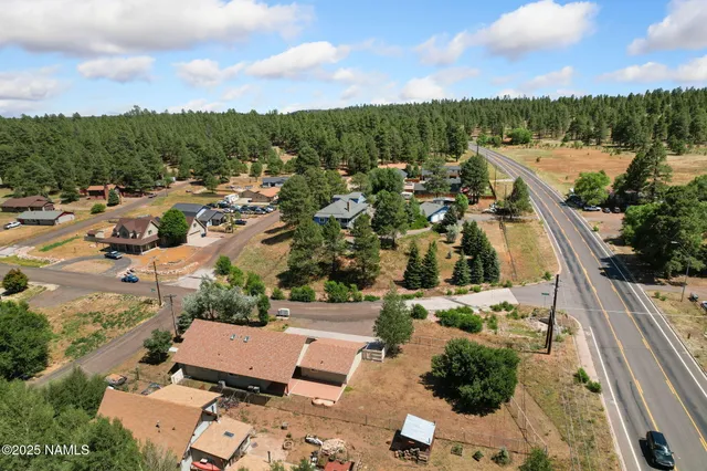 an aerial view of a house with outdoor space