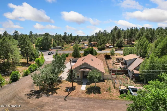 an aerial view of a house with a yard and lake view