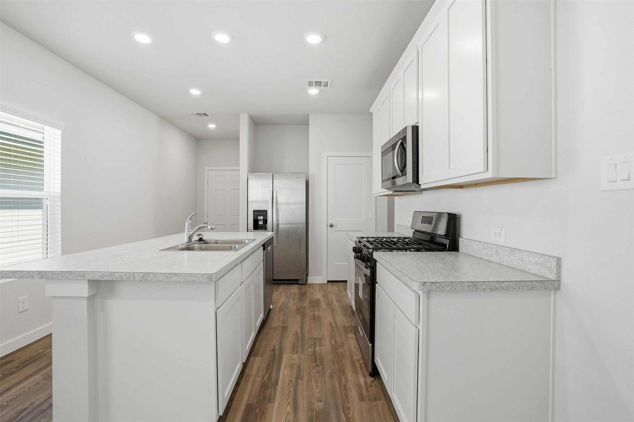 16994 Pandora Way Porter, TX 77365 - Photo 15 of 25 a kitchen with a sink stove and cabinets