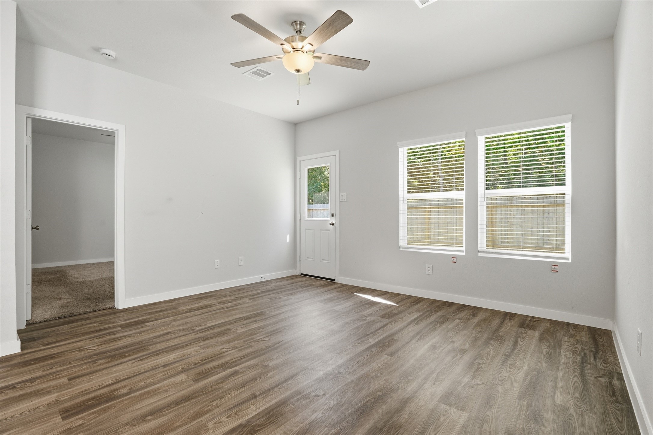 16994 Pandora Way Porter, TX 77365 - Photo 18 of 25 a view of an empty room with wooden floor and a window