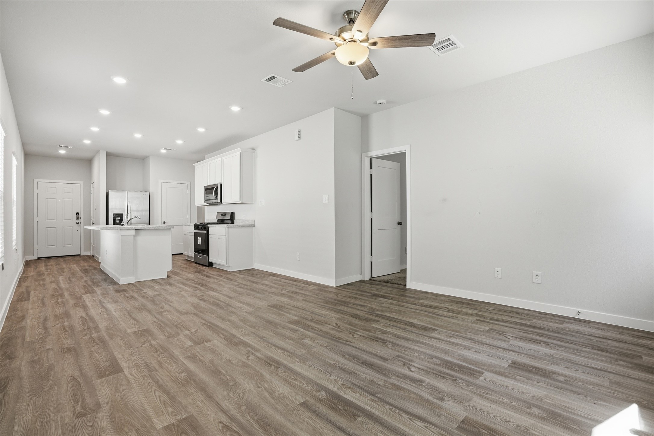 16994 Pandora Way Porter, TX 77365 - Photo 19 of 25 a view of a kitchen with a dishwasher and a refrigerator
