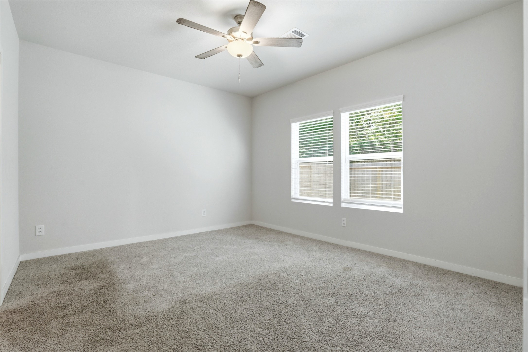 16994 Pandora Way Porter, TX 77365 - Photo 21 of 25 an empty room with a window and a fan