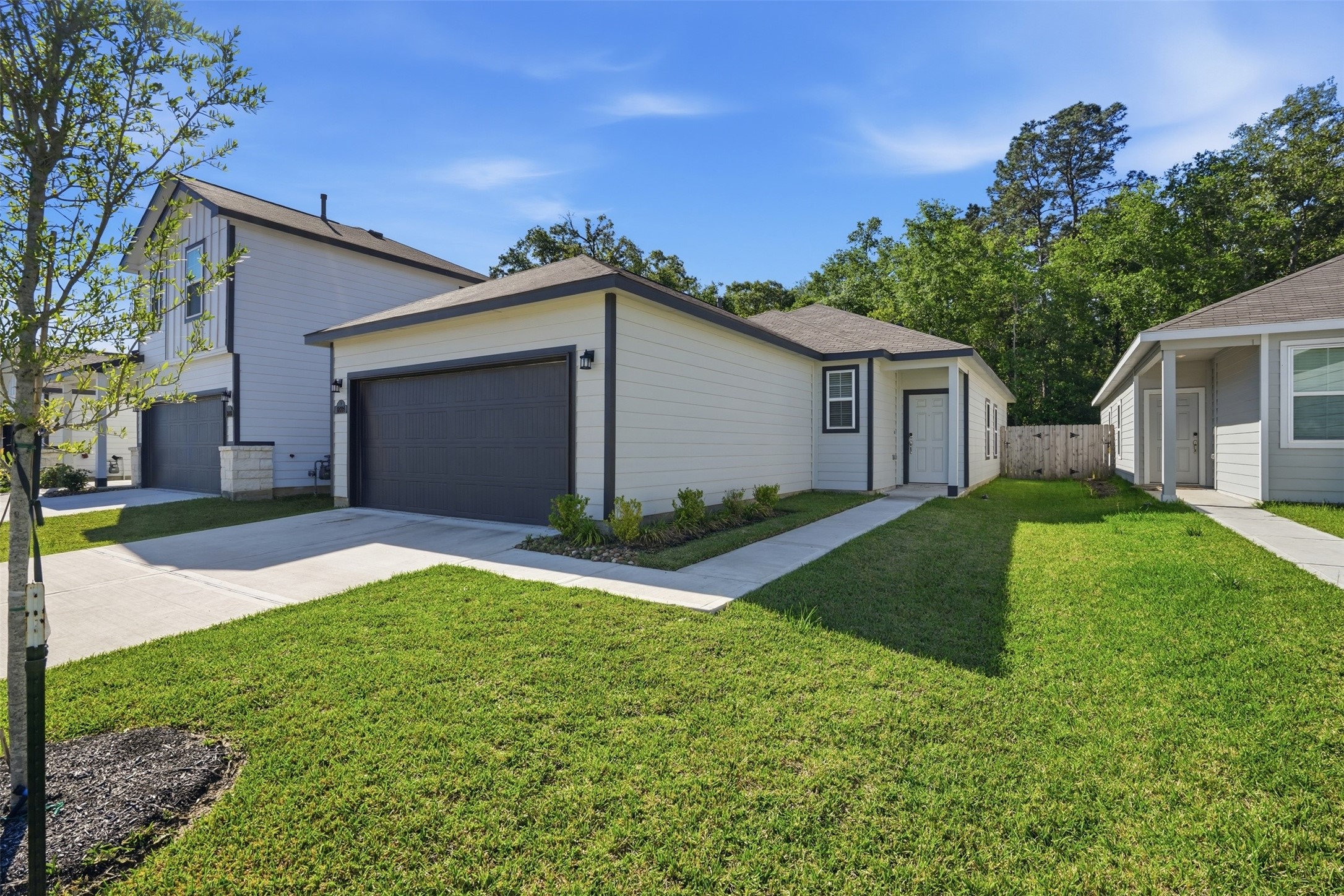 16994 Pandora Way Porter, TX 77365 - Photo 23 of 25 a front view of house with yard and green space
