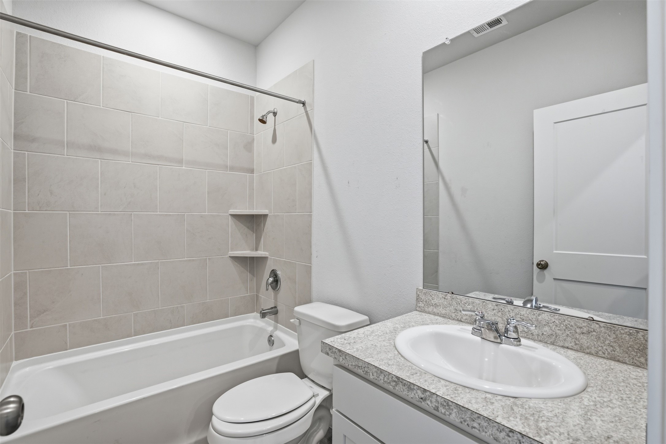16994 Pandora Way Porter, TX 77365 - Photo 6 of 25 a bathroom with a granite countertop sink toilet and shower