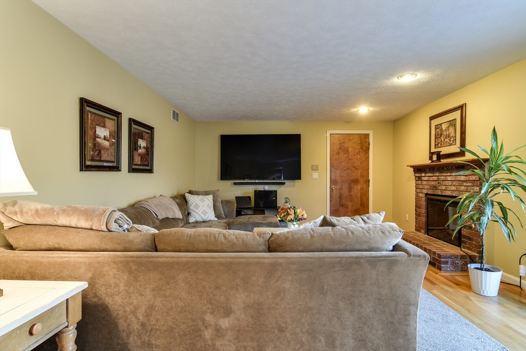 7 Gibbs Valley Path Framingham, MA 01701 - Photo 14 of 39 a living room with fireplace furniture and a flat screen tv