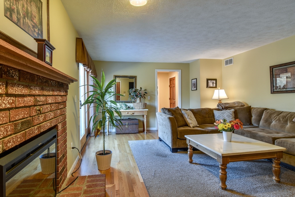 7 Gibbs Valley Path Framingham, MA 01701 - Photo 15 of 39 a living room with furniture and a fireplace