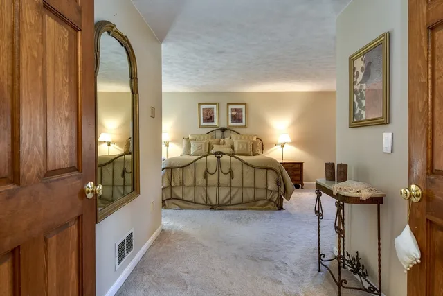 a bedroom with a bed and a mirror