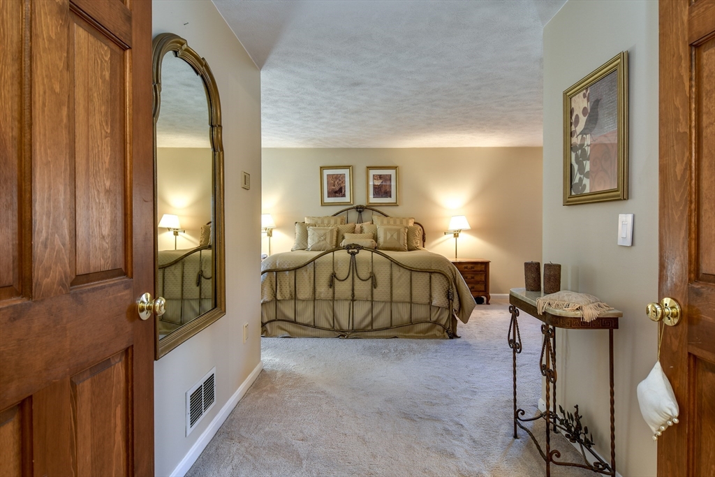 7 Gibbs Valley Path Framingham, MA 01701 - Photo 16 of 39 a bedroom with a bed and a mirror