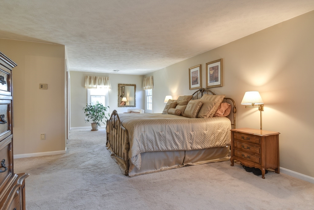 7 Gibbs Valley Path Framingham, MA 01701 - Photo 19 of 39 a spacious bedroom with a bed a lamp and window