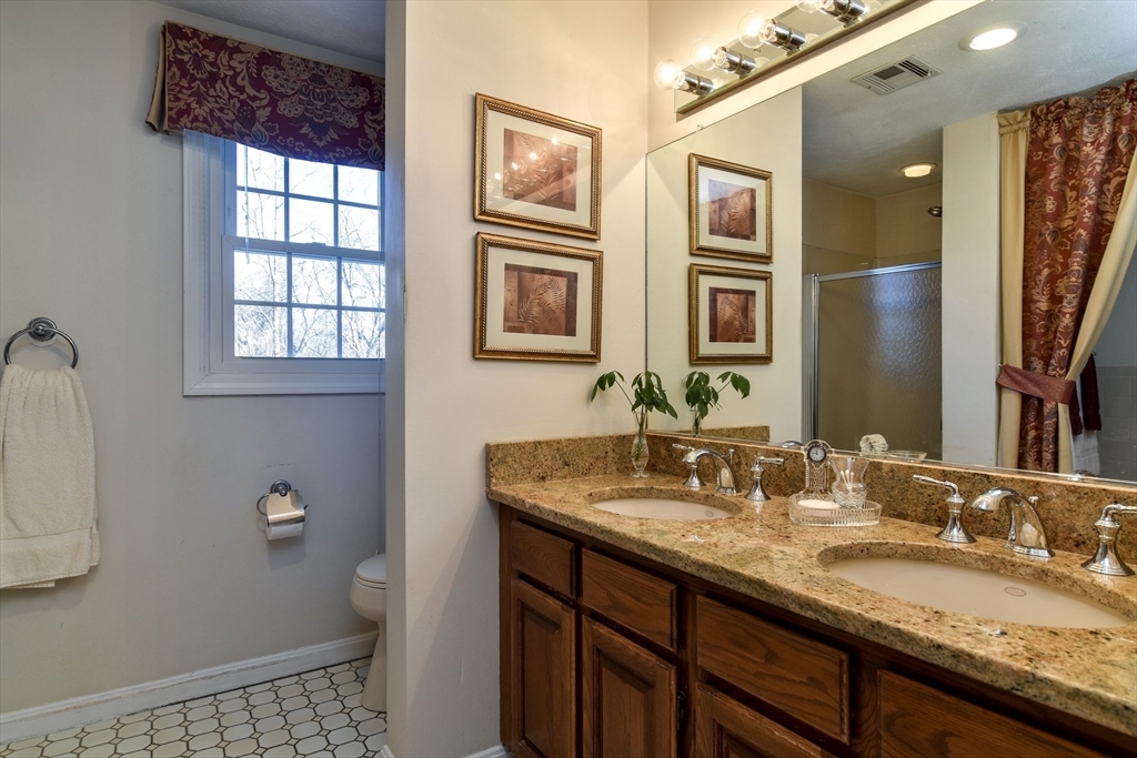 7 Gibbs Valley Path Framingham, MA 01701 - Photo 20 of 39 a bathroom with a granite countertop double vanity sink a mirror and a shower